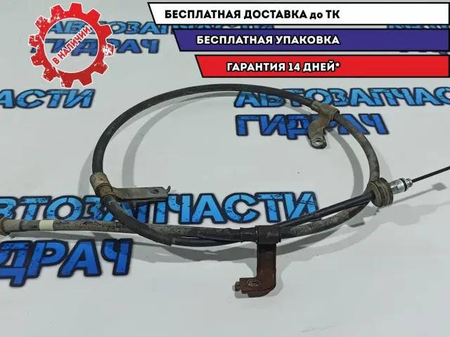 Трос стояночного тормоза левый Kia Rio 3 597601R300.